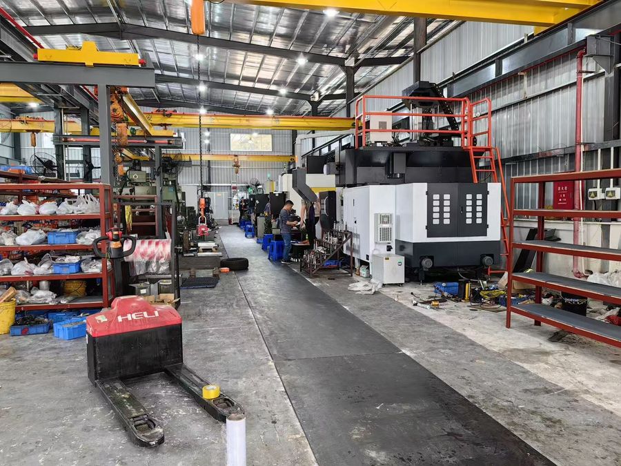 Hsingchao Mould workshop floor with multiple CNC machines, overhead crane and stock racks